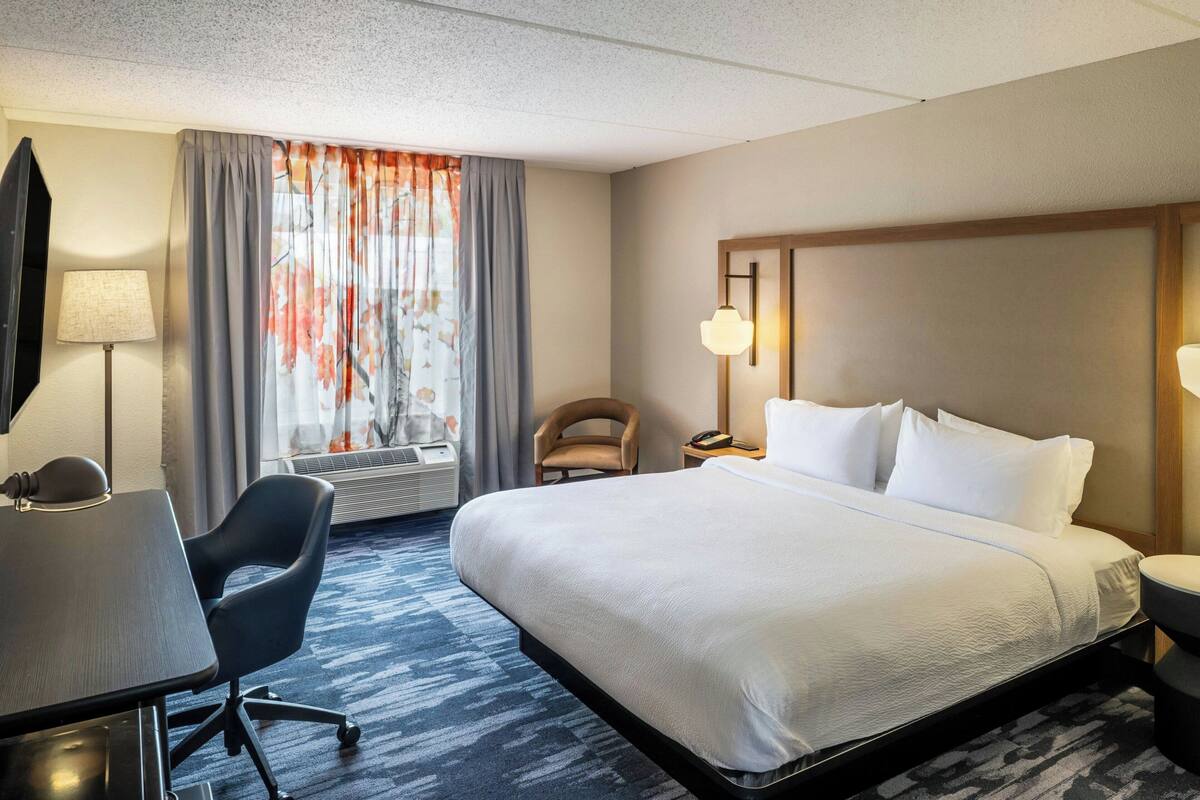 Premium bedding, desk, laptop workspace, blackout drapes