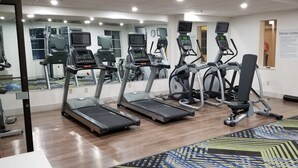 A fitness center with treadmills, elliptical machines, and a mirrored wall. - Holiday Inn Express Indiana by IHG (Indiana)