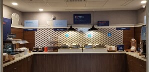 A breakfast area with labeled sections for bakery, hot food, and cereal. - Holiday Inn Express Indiana by IHG (Indiana)