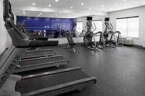 A gym with treadmills, elliptical machines, and a blue wall with motivational text. - Holiday Inn Express & Suites Wyomissing by IHG (Wyomissing)