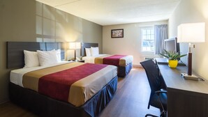 A hotel room with two beds, a desk, a chair, a TV, and a window with curtains. - Econo Lodge Harrisburg - Southwest of Hershey Area (Harrisburg)