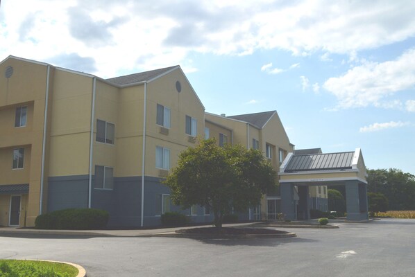 A multi-story hotel with a flat roof and a covered entrance.