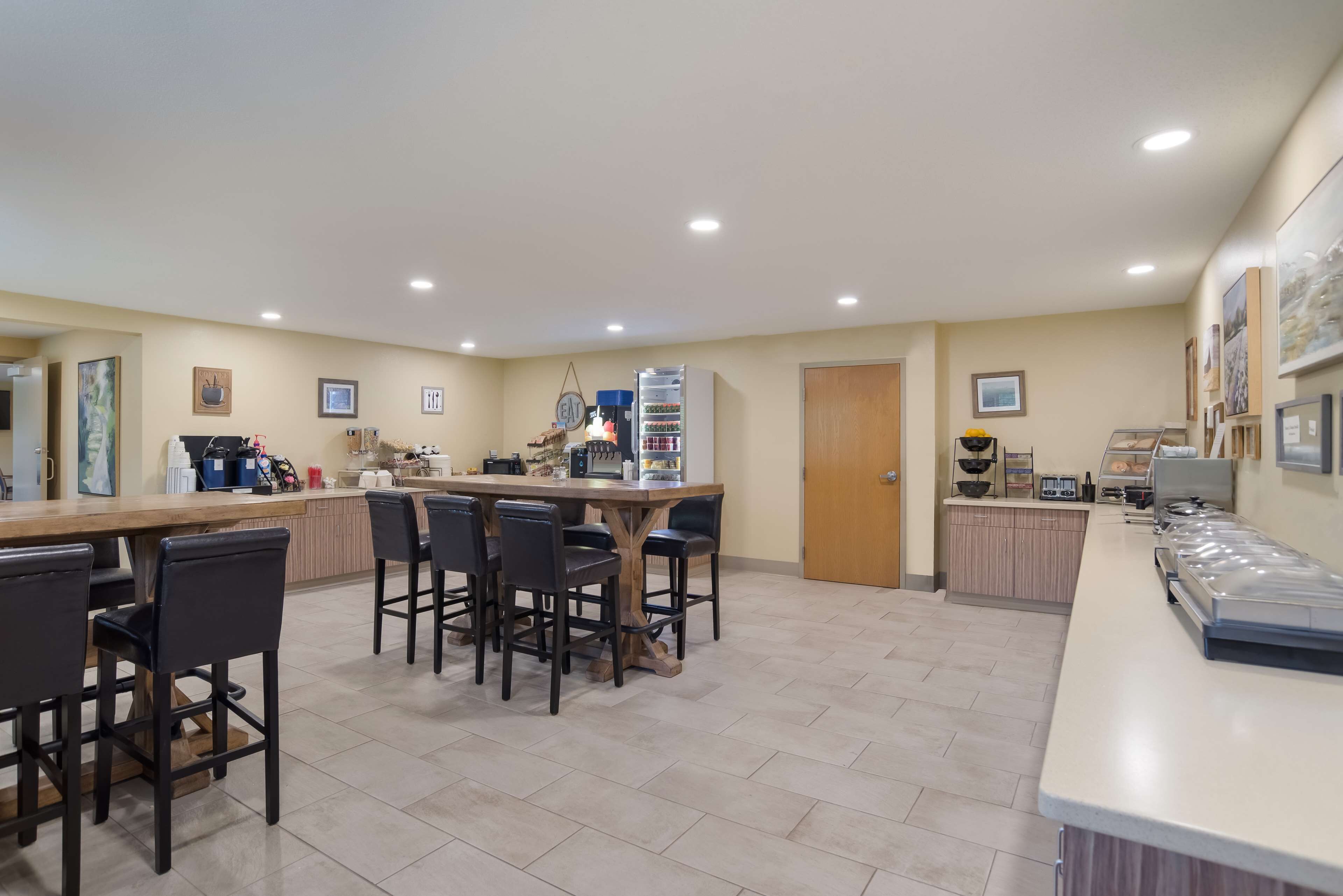 A spacious kitchen with a central island, bar stools, and a long counter.