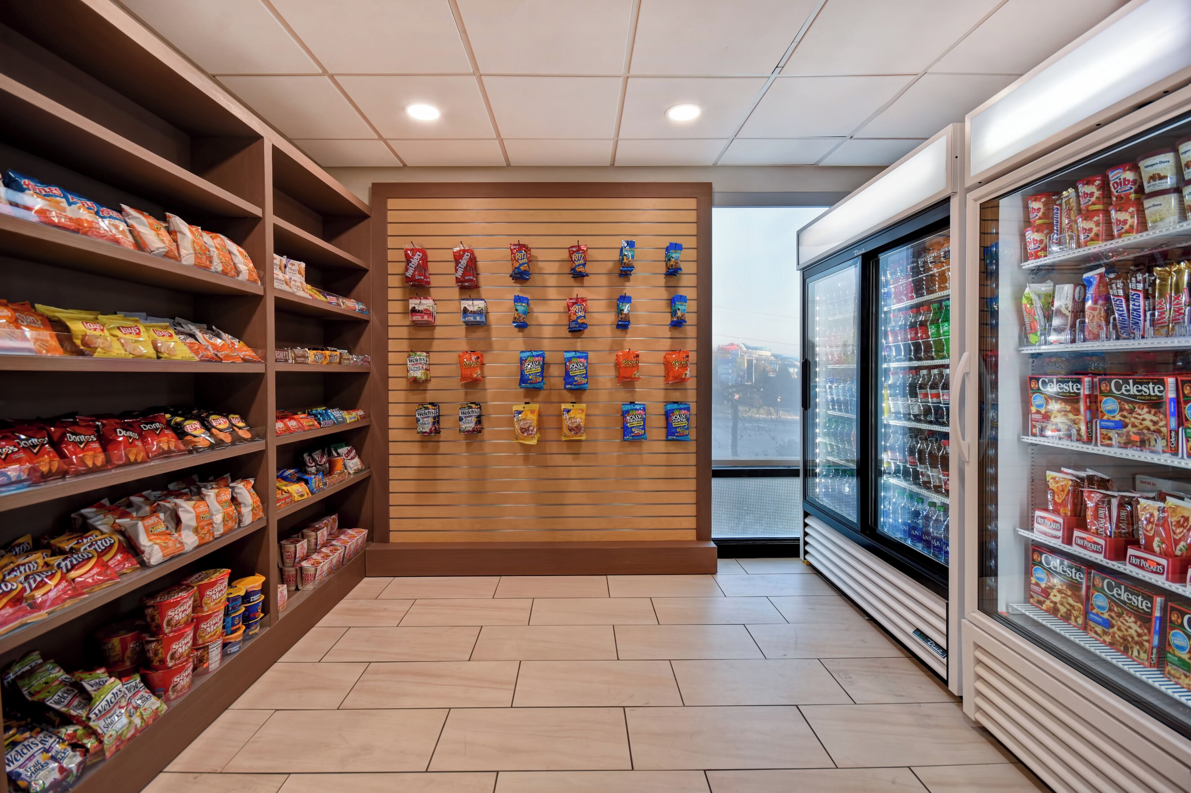 A snack aisle with shelves stocked with various chips and snacks.