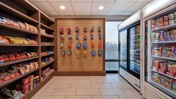 A snack aisle with shelves stocked with various chips and snacks.