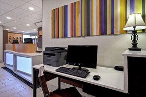 A modern office space with a desk, computer, printer, and a colorful abstract painting on the wall. - Holiday Inn Express & Suites Allentown-Dorney Park Area by IHG (Allentown)