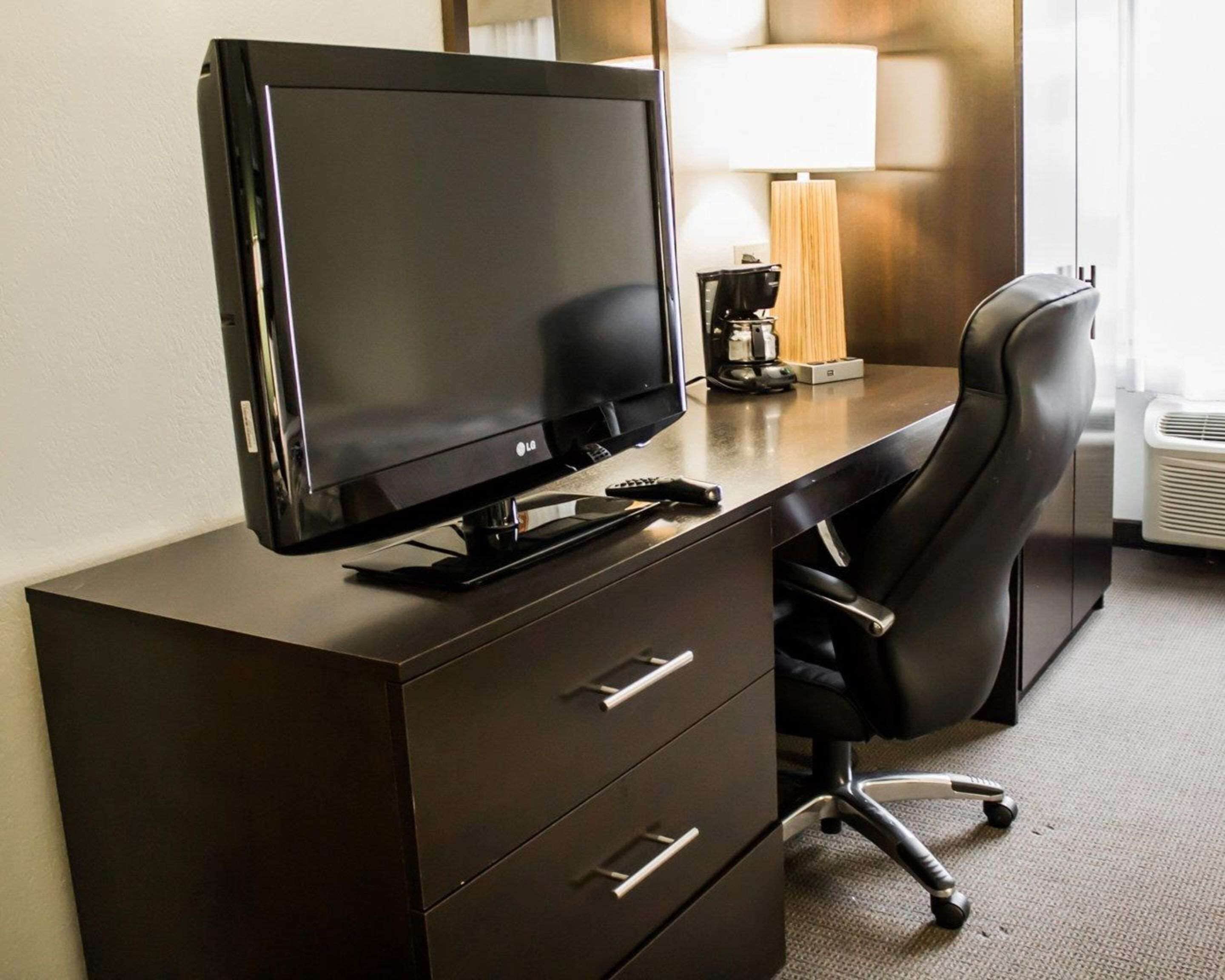 hypo-allergenic bedding, desk, laptop workspace, blackout curtains