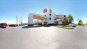 A hotel with a large parking lot, a prominent entrance, and a sign indicating it is a Holiday Inn Express. - Suburban Studios Johnstown - Richland Town Center (Johnstown)