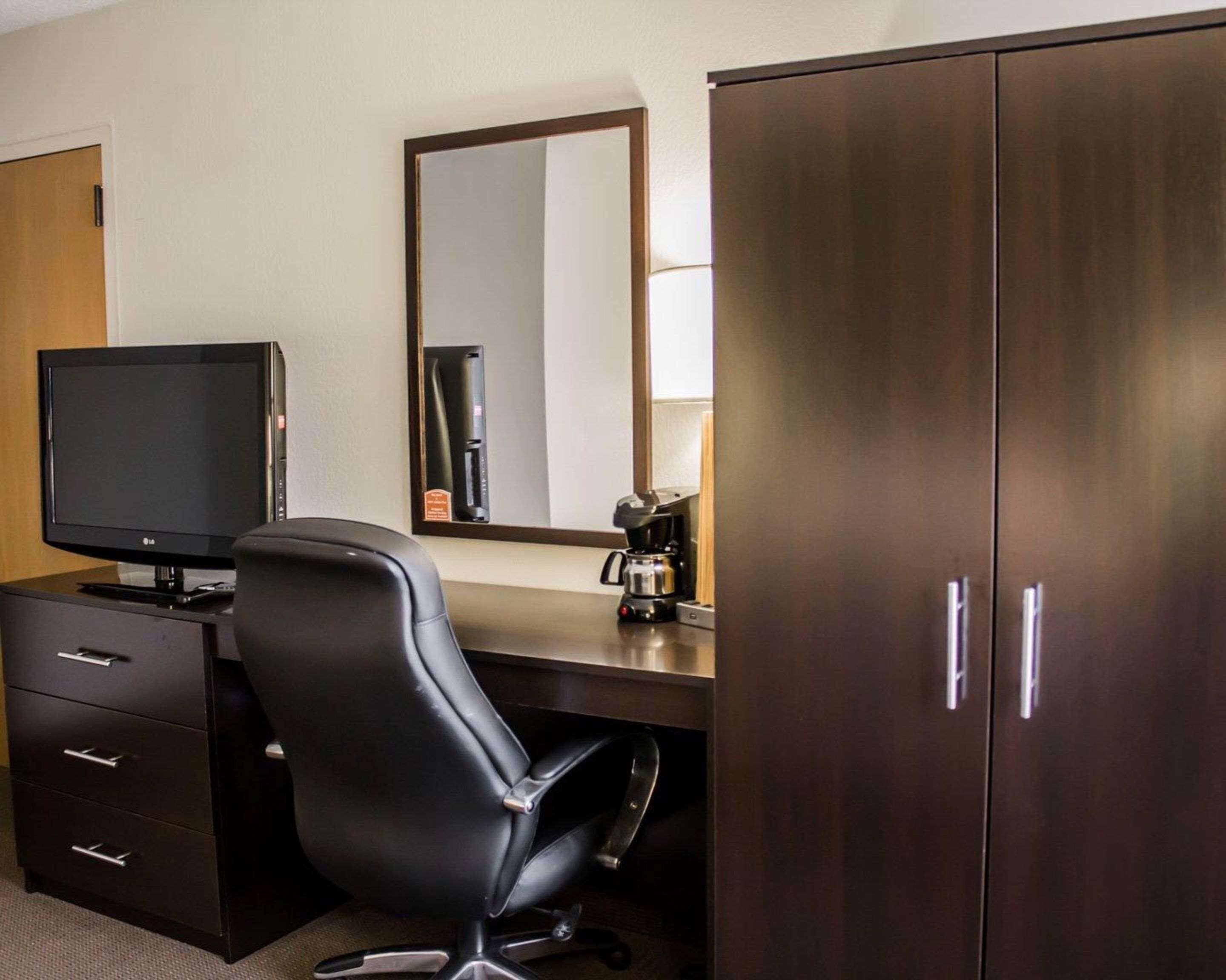 hypo-allergenic bedding, desk, laptop workspace, blackout curtains