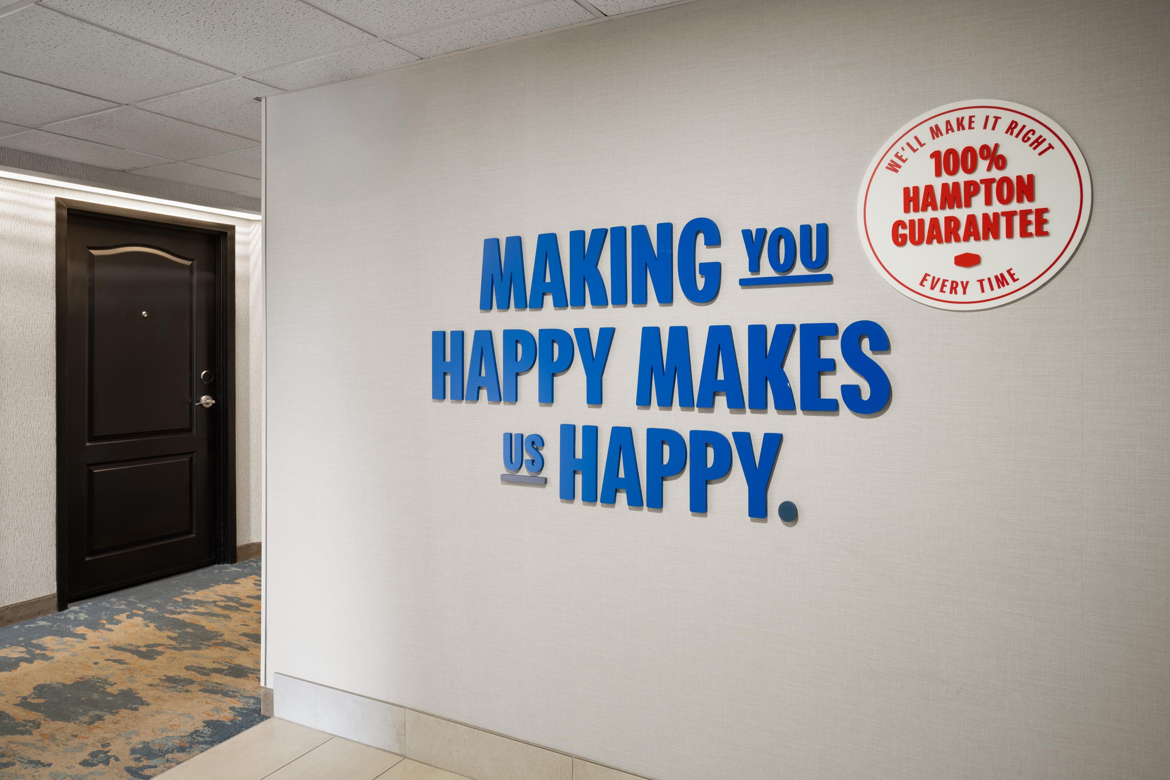 A wall with a motivational message and a Hampton Guaranty logo.