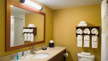 A bathroom with a sink, mirror, towel rack, and toilet.