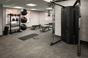 A gym with weightlifting equipment, benches, and a squat rack. - Fairfield by Marriott Inn & Suites Columbia Lexington (Lexington)