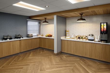 A modern kitchen with wooden cabinets, a herringbone floor, and a menu display.. Fairfield by Marriott Inn & Suites Columbia Lexington