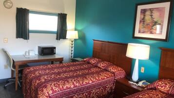 A hotel room with two beds, a desk, a microwave, a telephone, and a painting on the wall.