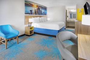 A hotel room with a bed, a desk, a chair, a bathroom, and a painting of a pier. - Days Inn by Wyndham Barnwell (Barnwell)
