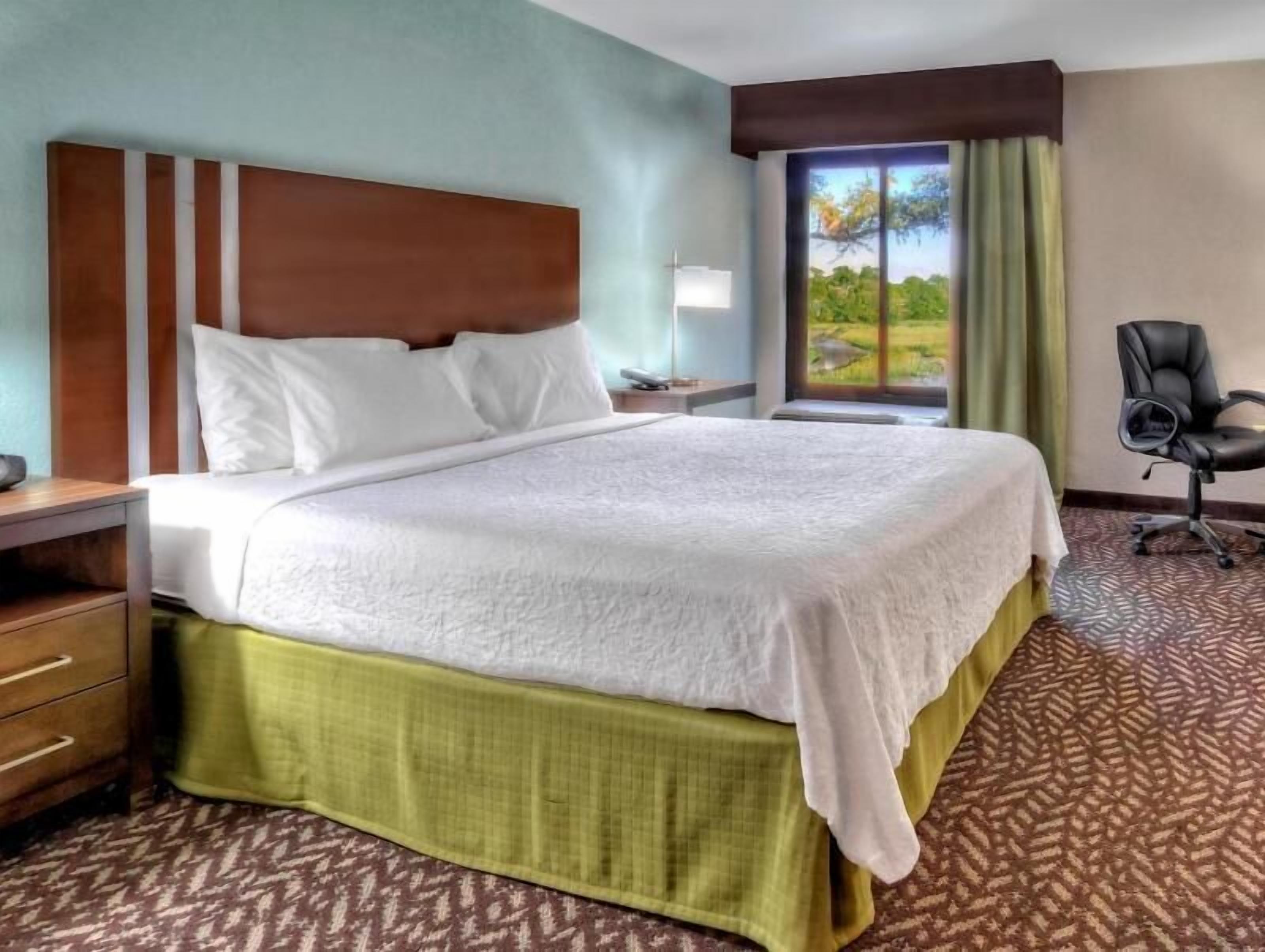 Premium bedding, desk, laptop workspace, blackout drapes