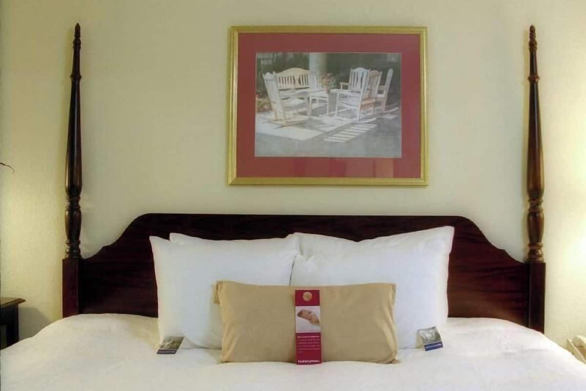 Premium bedding, desk, laptop workspace, blackout drapes