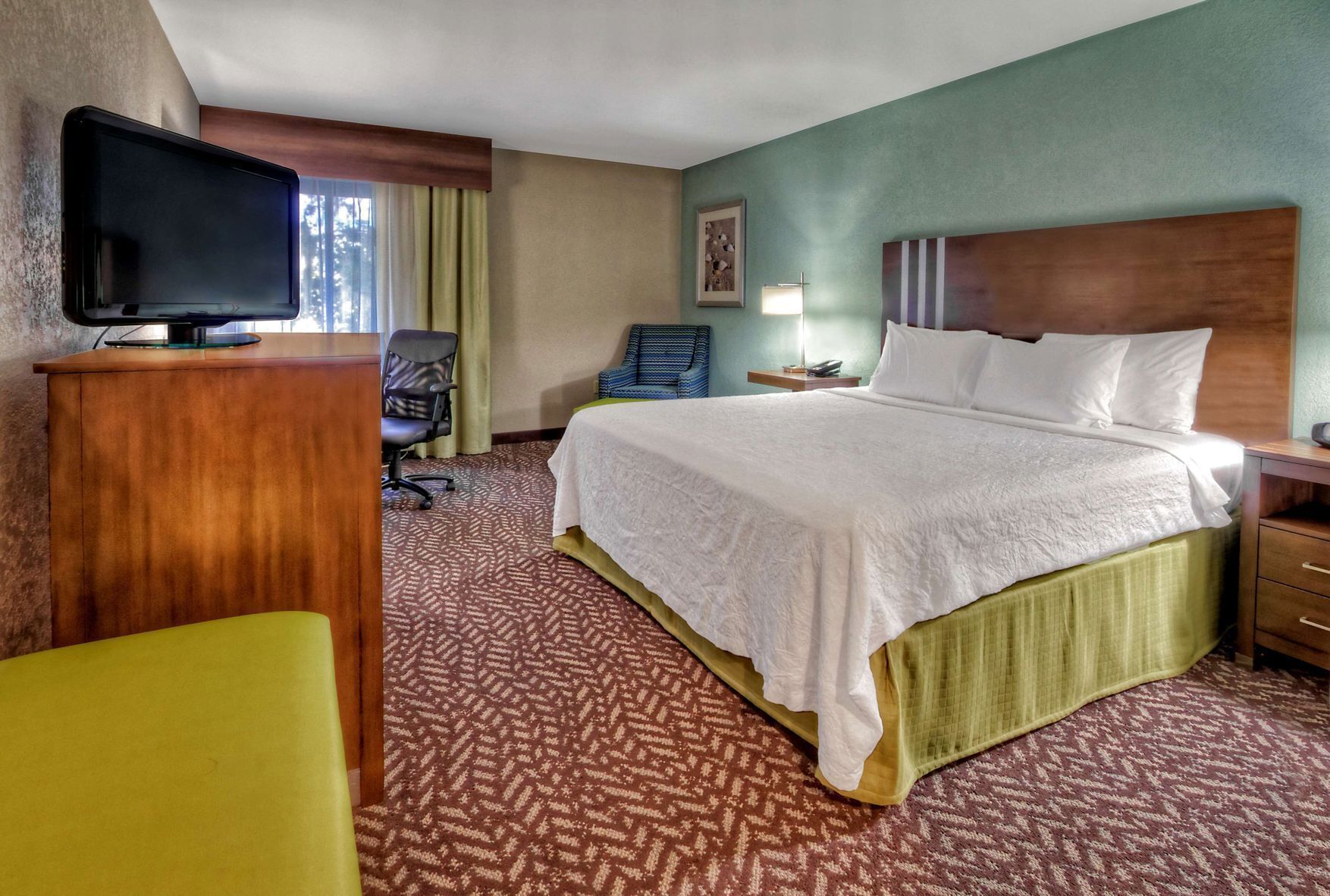 Premium bedding, desk, laptop workspace, blackout drapes