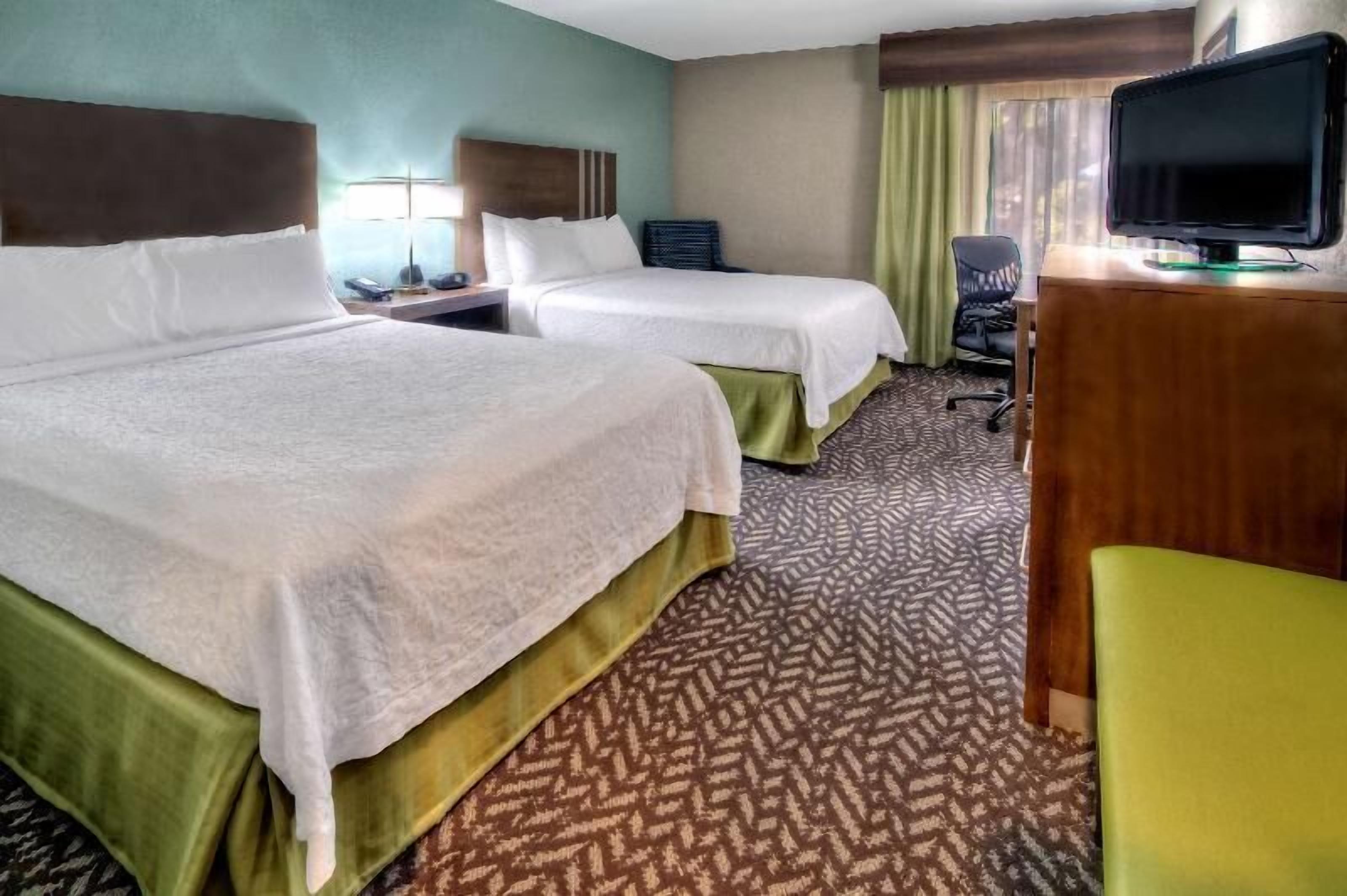 Premium bedding, desk, laptop workspace, blackout drapes