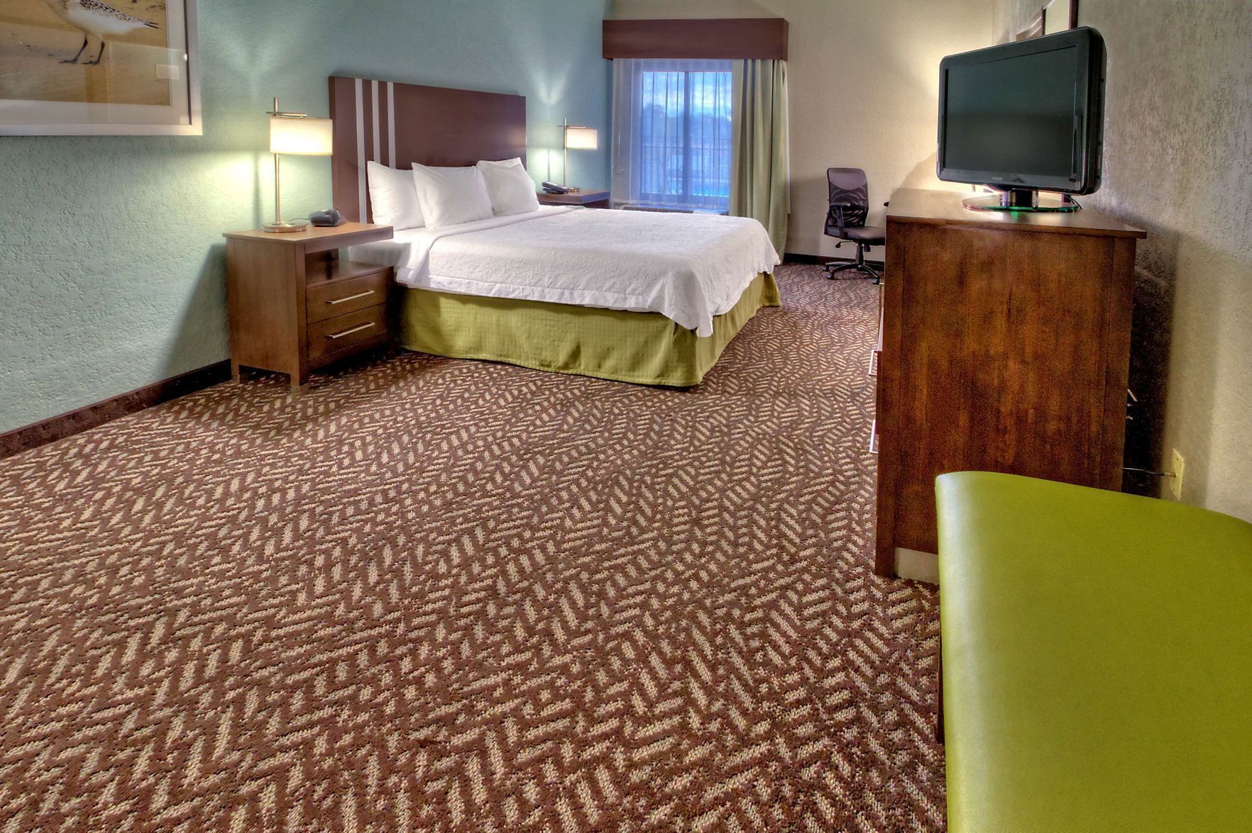 Premium bedding, desk, laptop workspace, blackout drapes
