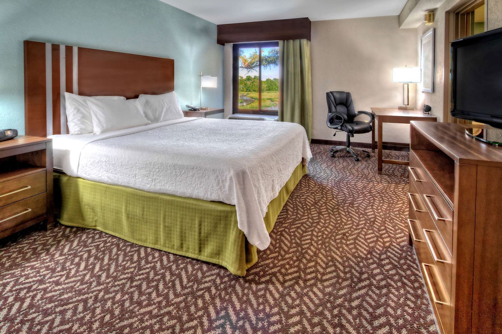 Premium bedding, desk, laptop workspace, blackout drapes
