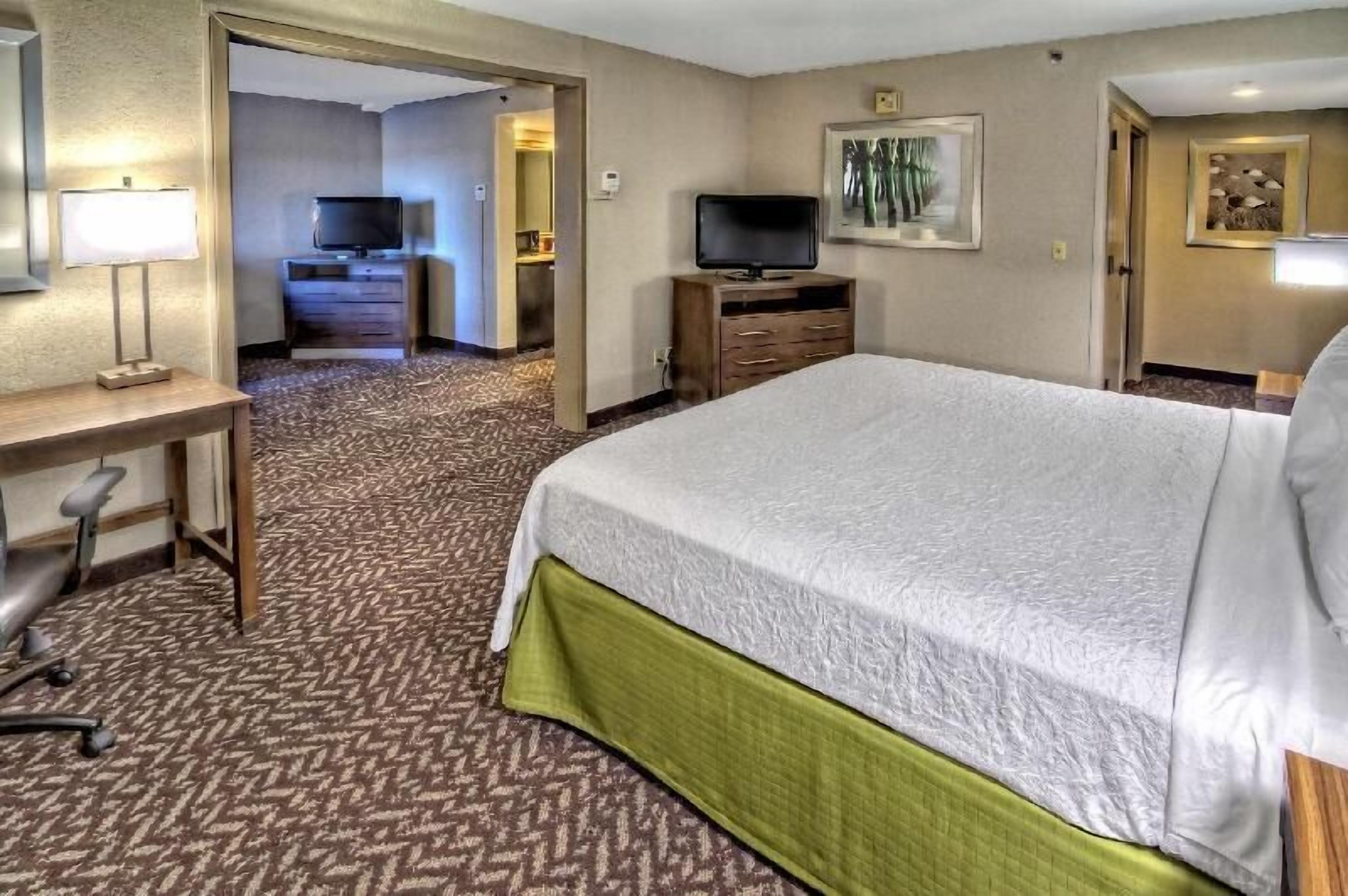 Premium bedding, desk, laptop workspace, blackout drapes
