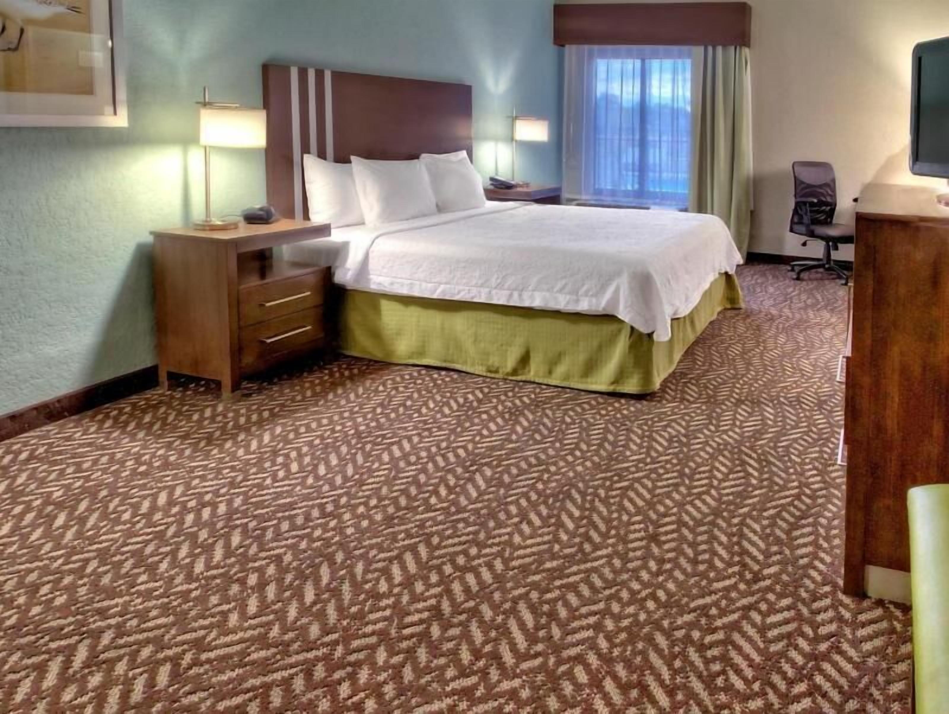 Premium bedding, desk, laptop workspace, blackout drapes