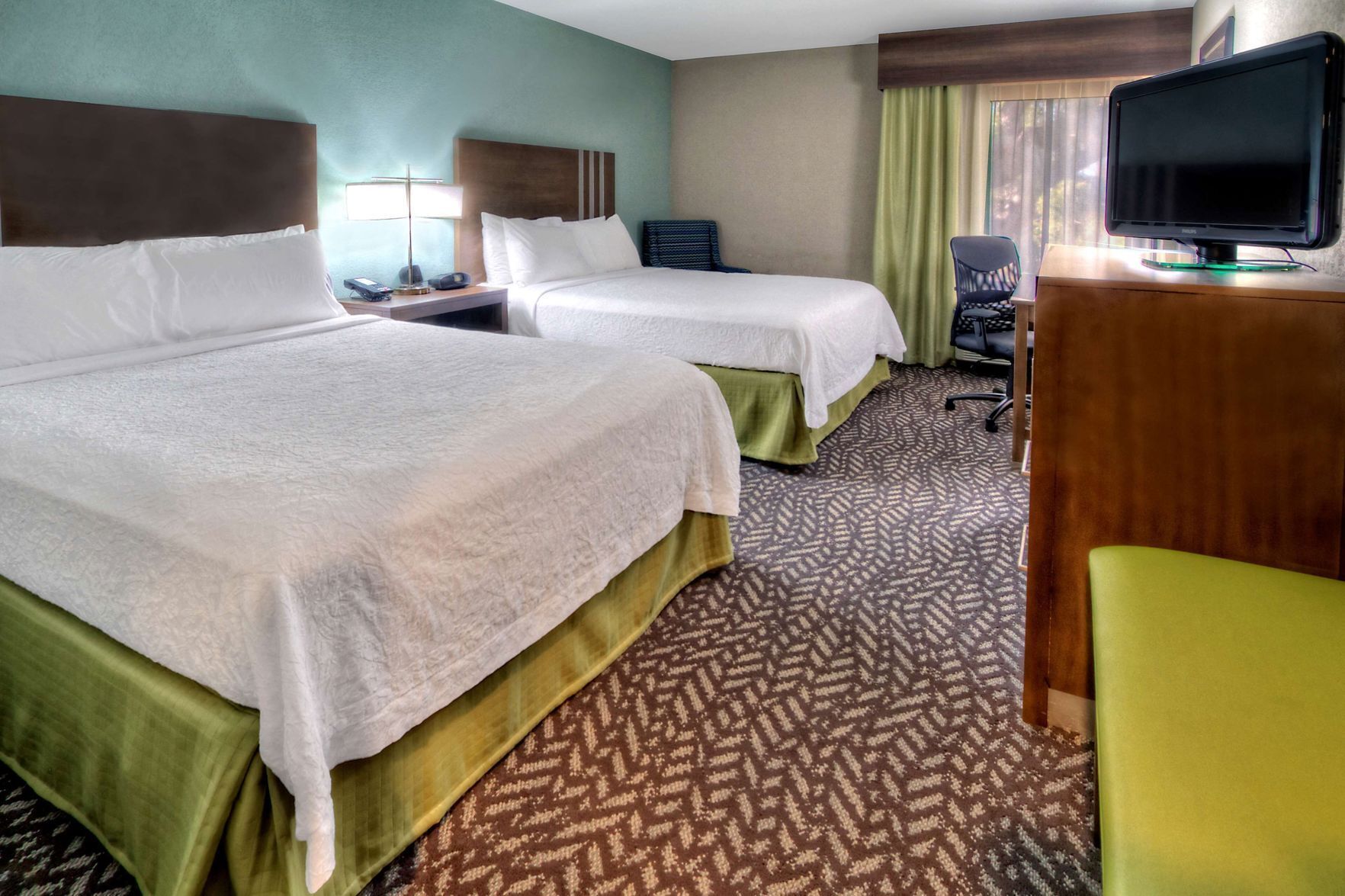 Premium bedding, desk, laptop workspace, blackout drapes