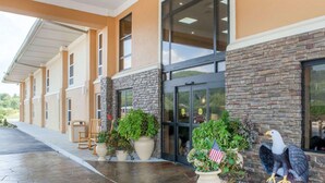 A building with a stone facade, large windows, and outdoor seating. - Comfort Inn at Royal Blue (Pioneer)