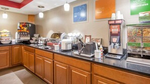 A breakfast bar with coffee machines, a fruit display, and a cereal dispenser. - Comfort Inn at Royal Blue (Pioneer)