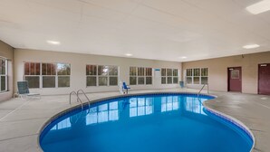 An indoor swimming pool with clear blue water, surrounded by windows and a tiled floor. - Red Roof Inn & Suites Knoxville East (Knoxville)