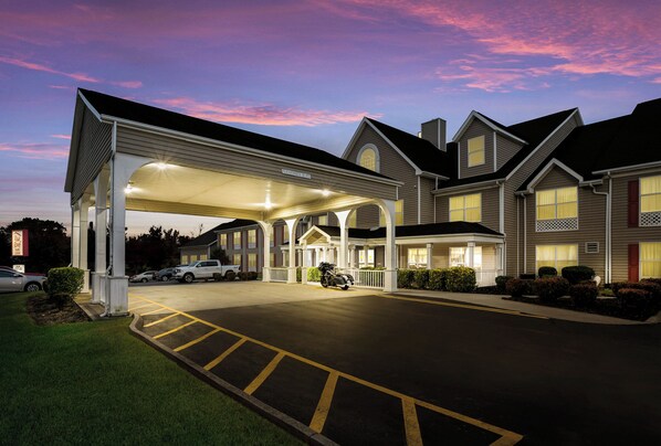 A hotel with a covered parking area, multiple entry points, and a landscaped driveway. - Red Roof Inn & Suites Knoxville East (Knoxville)