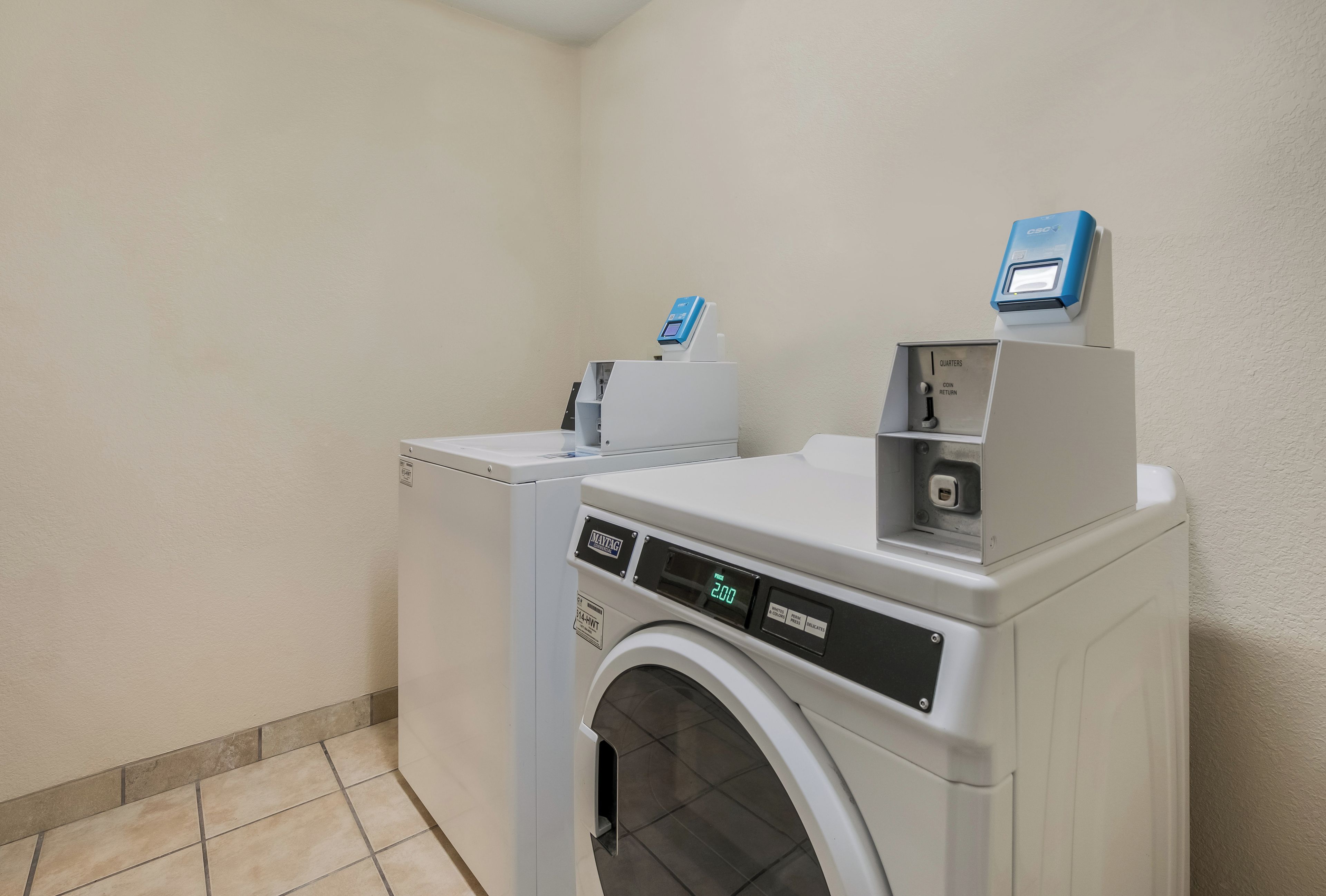 A laundry room with a front-loading washing machine and a dryer.