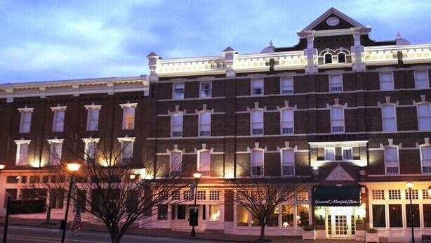 A large, multi-story hotel with a classic architectural style, featuring a prominent entrance and multiple windows. - General Morgan Inn (Greeneville)