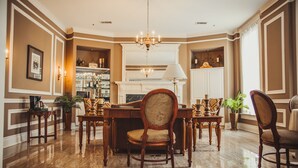 A formal dining room with a chandelier, wooden furniture, and a fireplace. - General Morgan Inn (Greeneville)