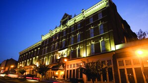 A historic building with multiple stories, large windows, and a classic architectural style.