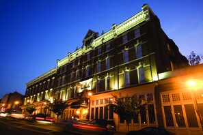 A historic building with multiple stories, large windows, and a classic architectural style.
