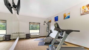 A gym with exercise equipment, large windows, and artwork on the walls. - Comfort Inn Brownsville I-40 (Brownsville)