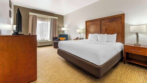 A hotel room with a large bed, a desk, a chair, and a TV. - Comfort Inn Brownsville I-40 (Brownsville)