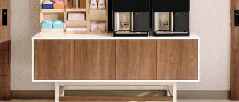 A kitchen with a wooden cabinet, a coffee machine, and various kitchen items.