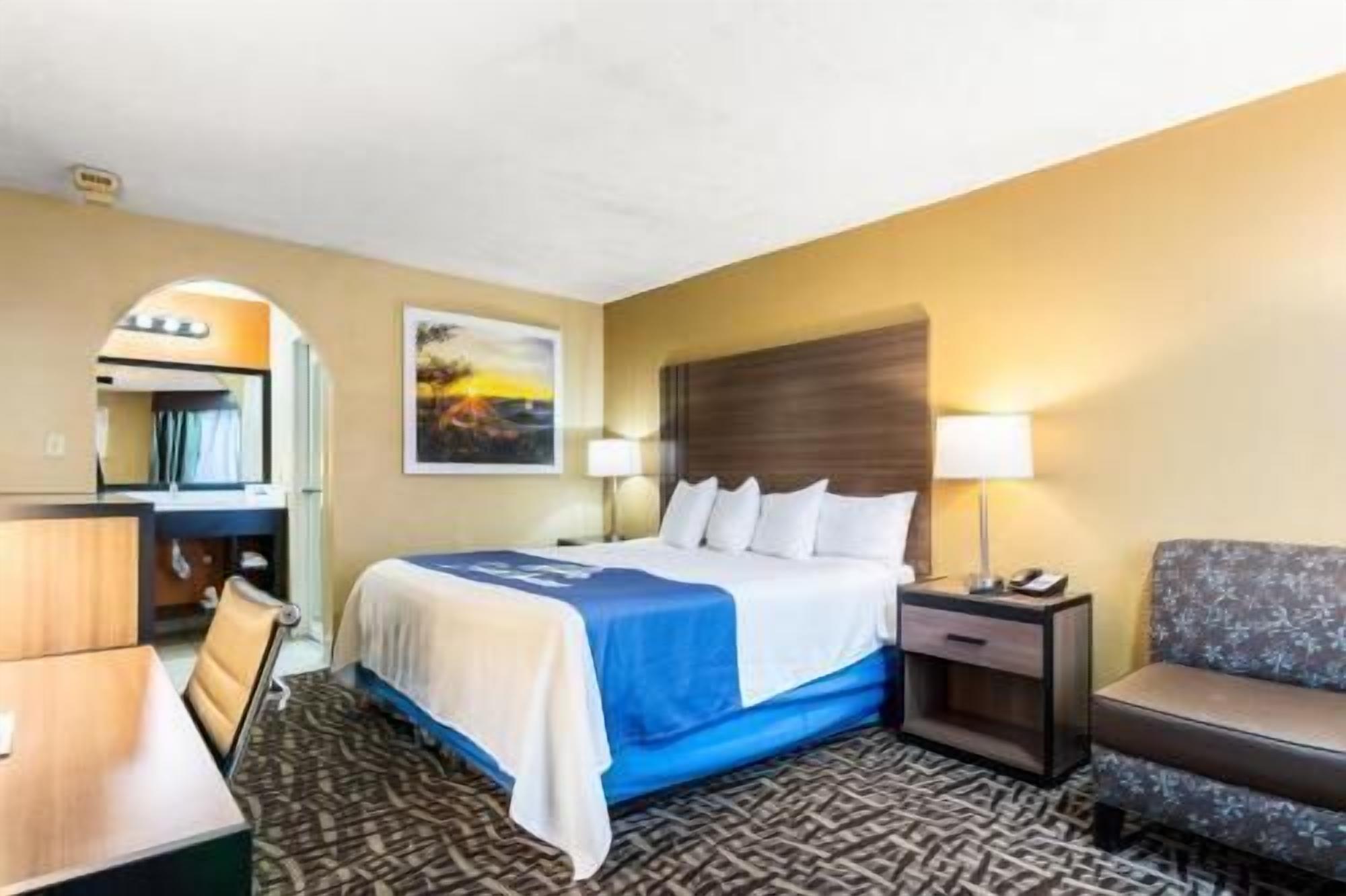 Premium bedding, desk, laptop workspace, iron/ironing board