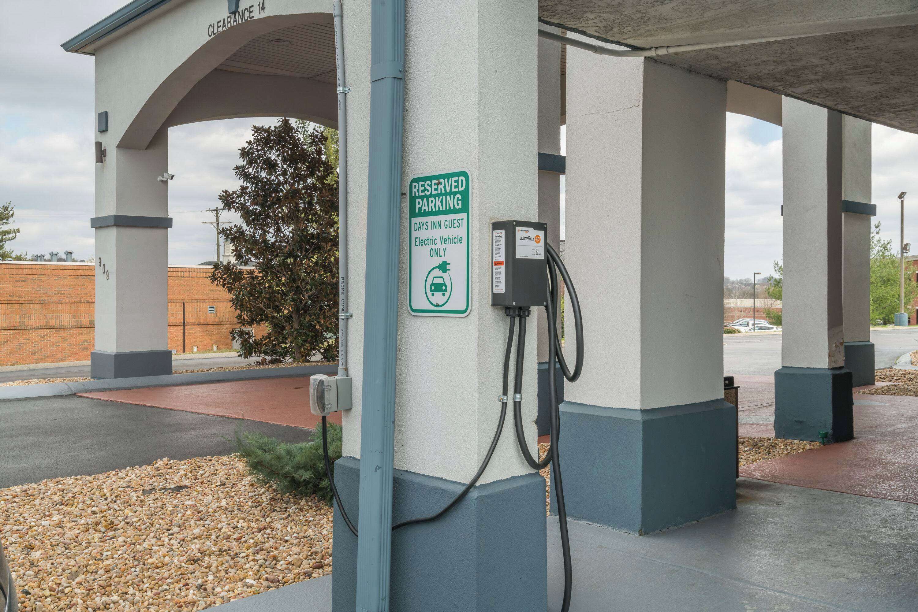 A parking area with a sign indicating reserved parking for electric vehicles only.