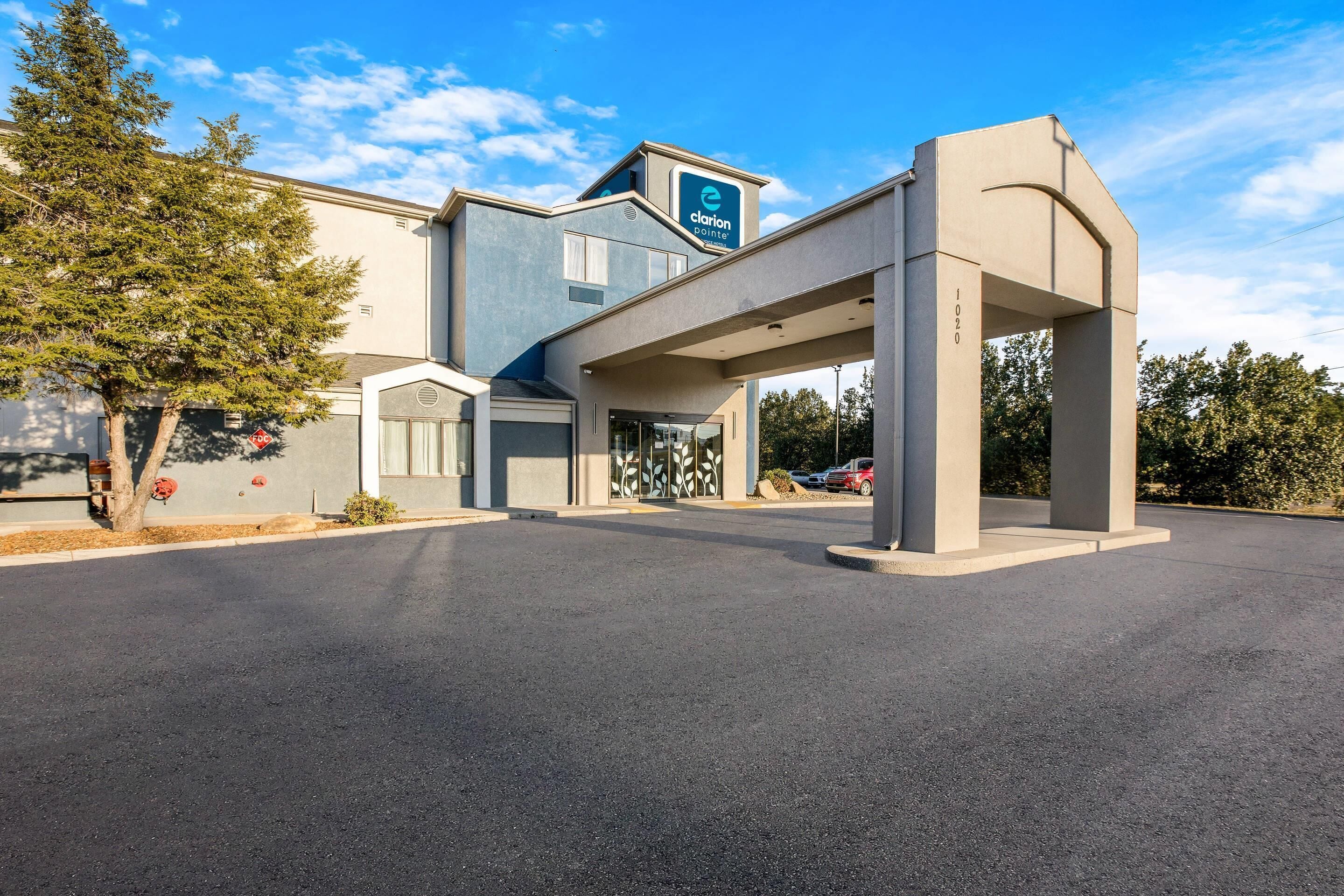 A modern building with a 'Clarion Pointe' sign, a covered entrance, and a parking lot.
