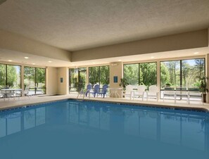 Relax by the pool surrounded by comfortable lounge chairs and tables.