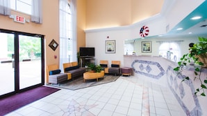 A hotel lobby with seating, a reception desk, and a large window. - Best Western Pearland Inn (Pearland)