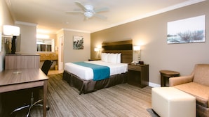 A hotel room with a bed, desk, chair, and a small couch. - Best Western Pearland Inn (Pearland)