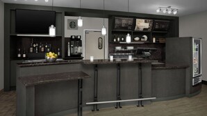 Una cocina moderna con barra, electrodomésticos integrados y un televisor de pantalla plana.
