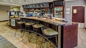 A bar area with a curved counter, bar stools, and a menu board. - Courtyard by Marriott Abilene Southwest/Abilene Mall South (Abilene)
