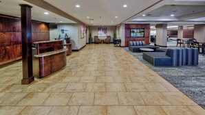 A hotel lobby with a reception desk, seating area, and a television screen. - Courtyard by Marriott Abilene Southwest/Abilene Mall South (Abilene)