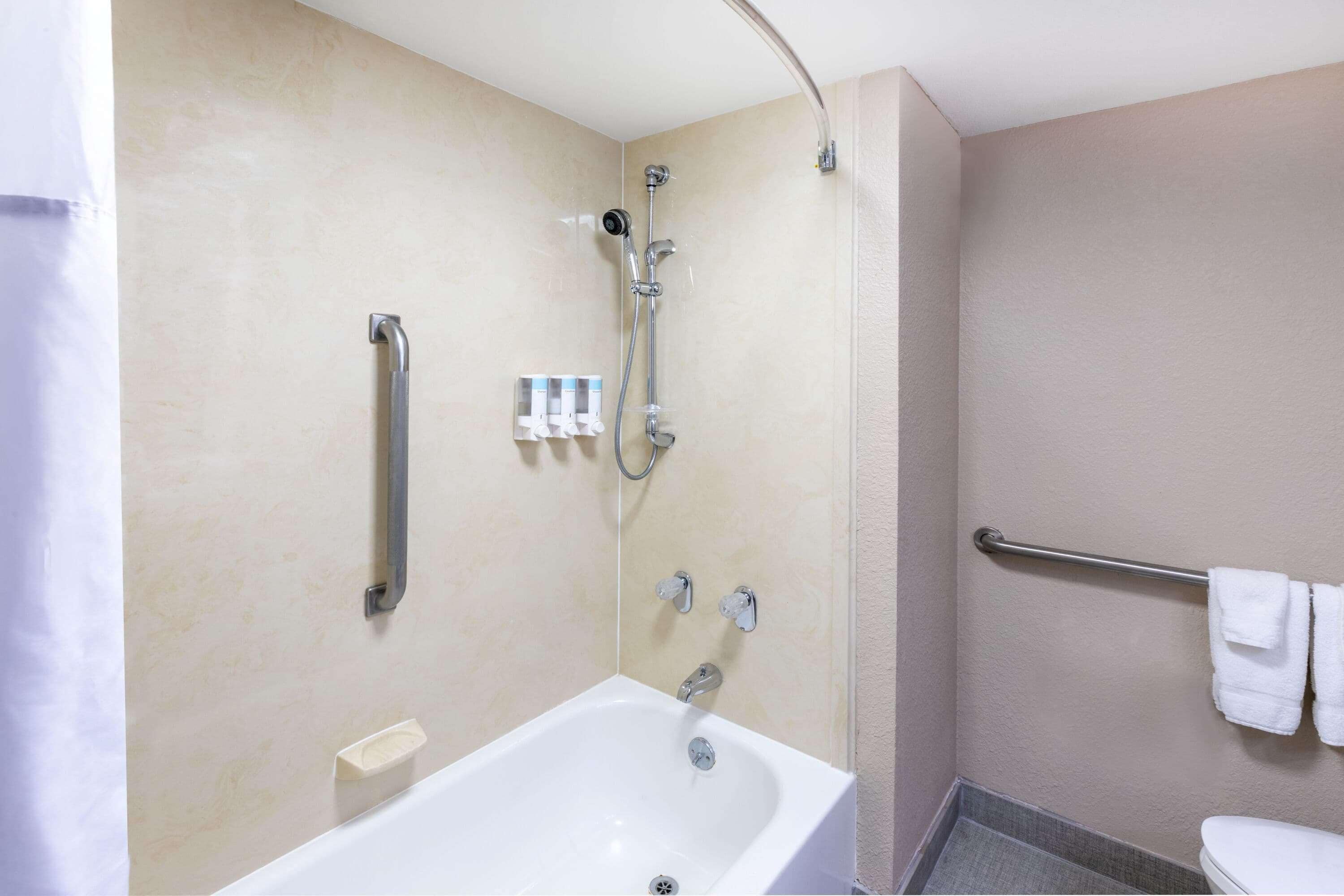 A bathroom with a bathtub, a shower, and a toilet.